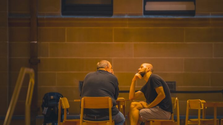 Two adults seated across a table in a calm conversation