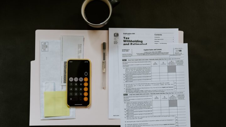 Financial statements and a calculator laid out on a desk
