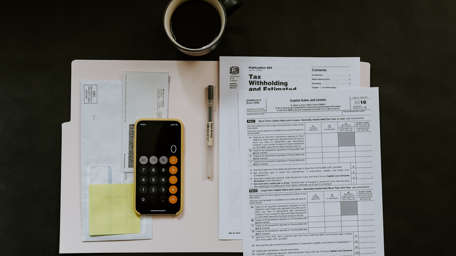 Financial statements and a calculator laid out on a desk