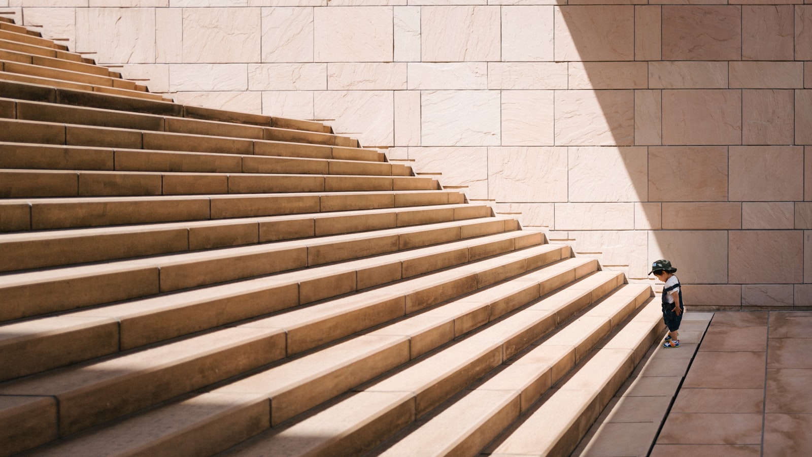 A wide stone staircase rising between plain walls