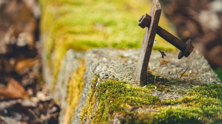 A pair of keys resting on a plain concrete surface
