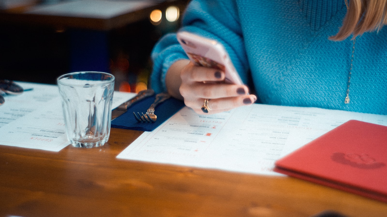 A person seated at a desk reading a letter