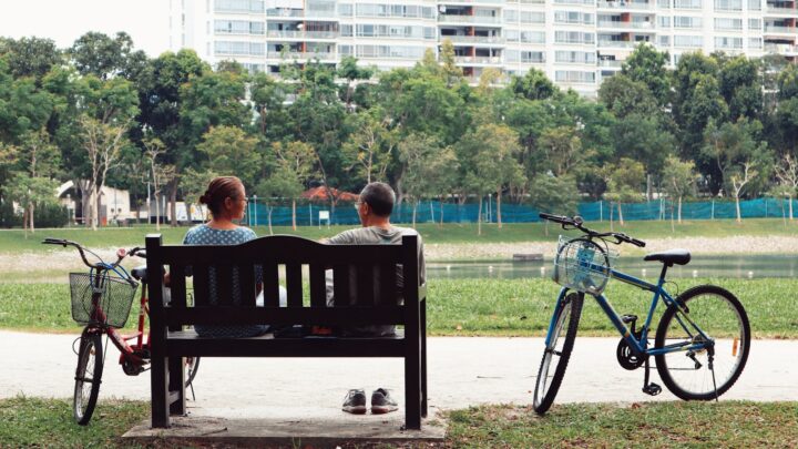 Father cycling with his child in a park