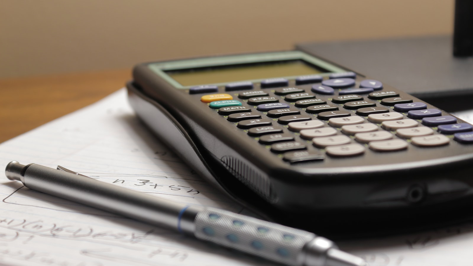 School supplies and a calculator laid out on a desk