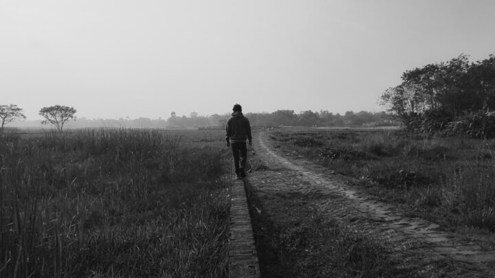 A child's bicycle parked alone on a quiet path