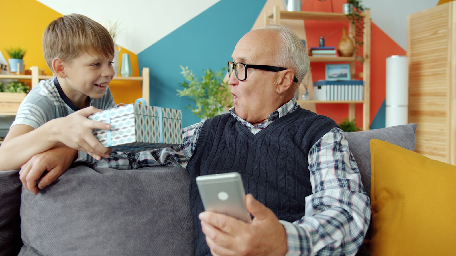 An adult and an older relative talking together in a living room