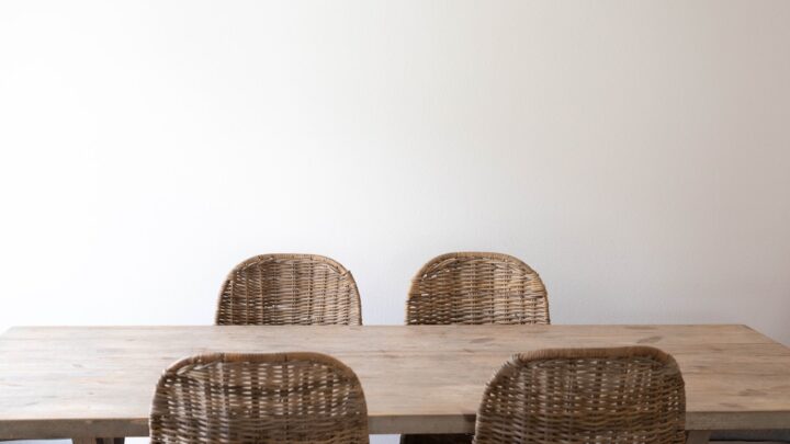 A pair of chairs at a simple wooden table in a home