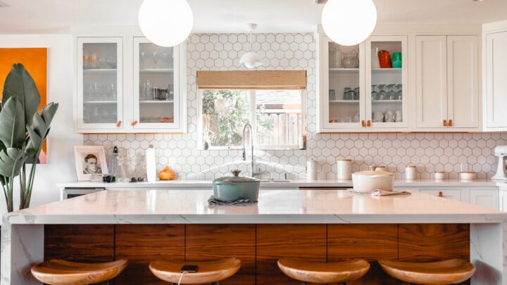 Two sets of keys on a kitchen counter beside a plant