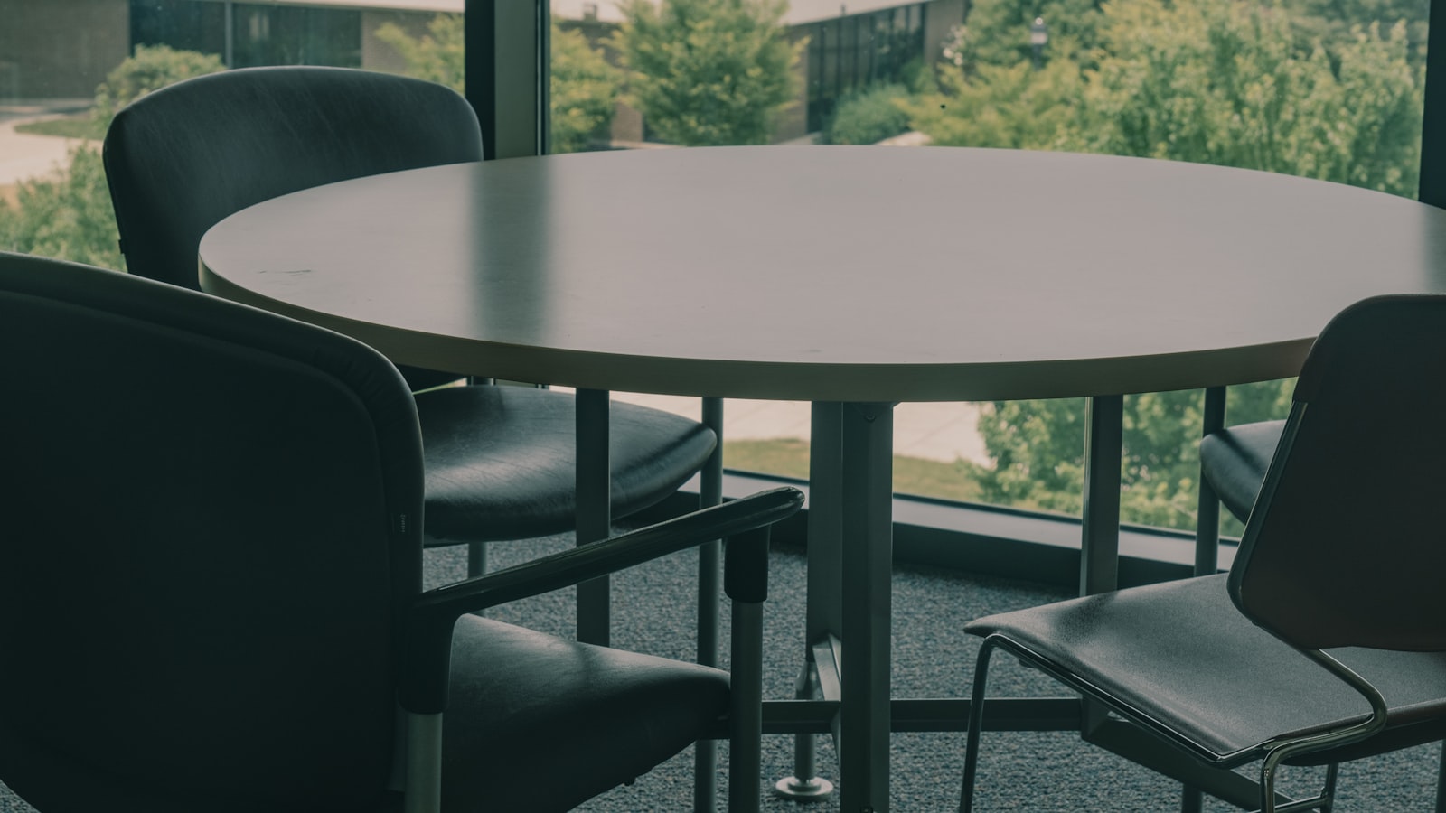 Four people seated around a table in a quiet meeting room