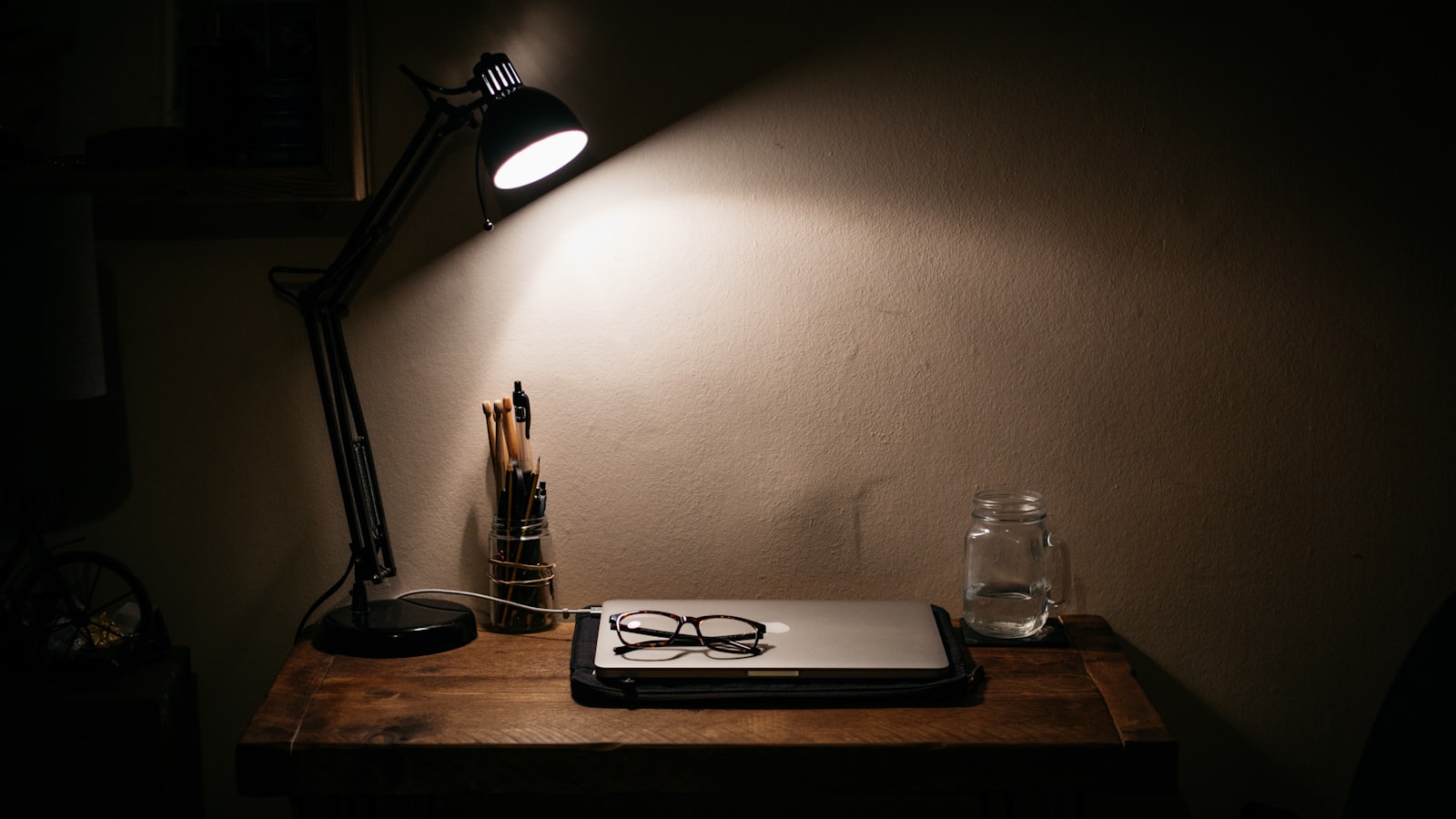 An old document on a desk under a lamp