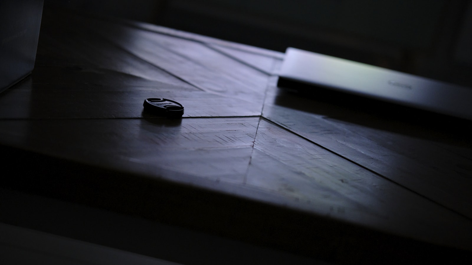 Metal coins resting on a dark wooden surface