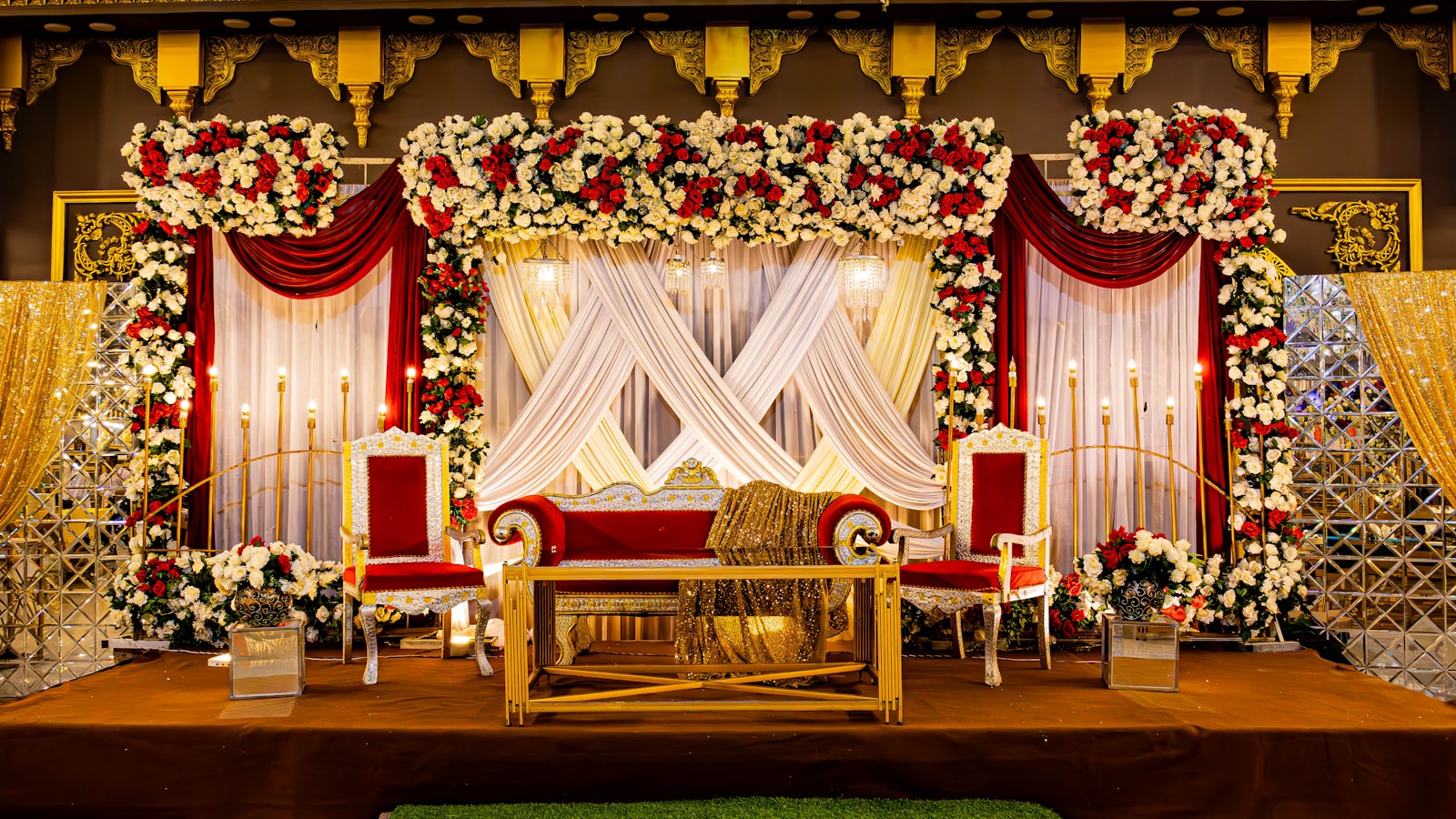 Red and gold traditional wedding decorations on a table
