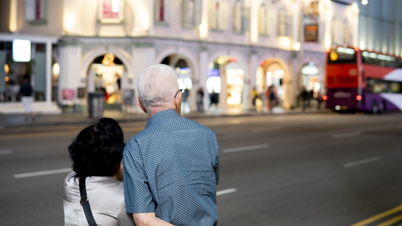 A caregiver supporting an elderly person in Singapore