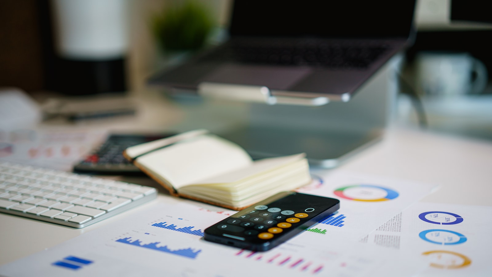 Financial statements and a calculator laid out on a desk