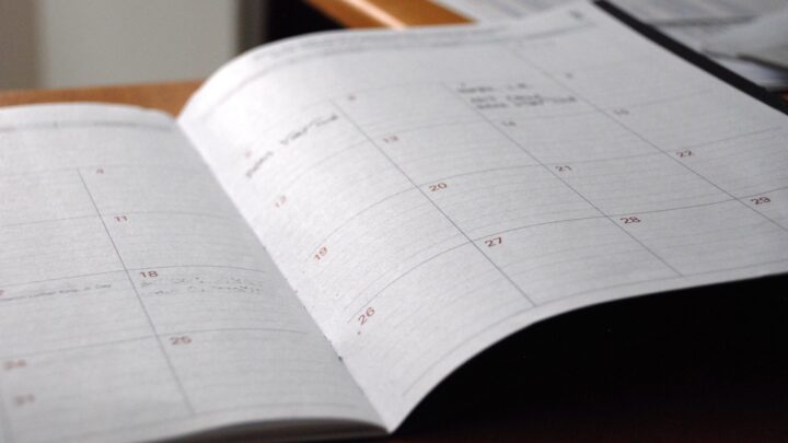 Calendar and clock on a desk marking the passage of time