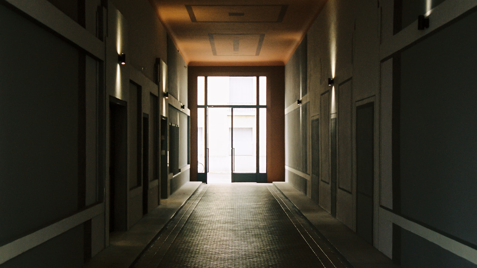 A quiet hall with soft daylight coming through tall windows