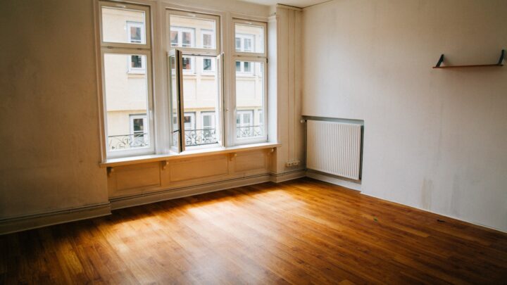 An empty room with sunlight falling across a bare floor