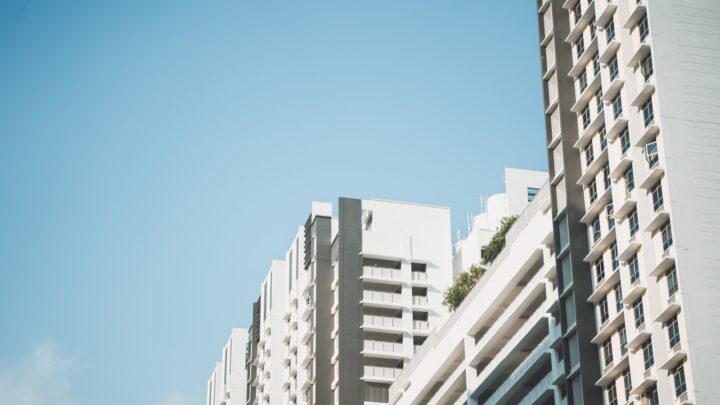 Singapore public housing blocks photographed from below against a clear sky