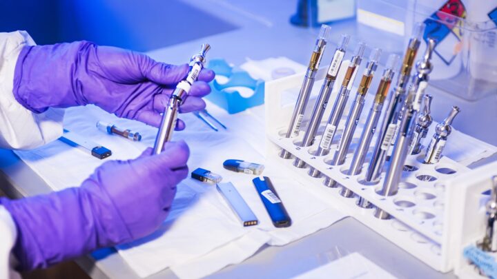 A row of glass test tubes standing in a laboratory rack