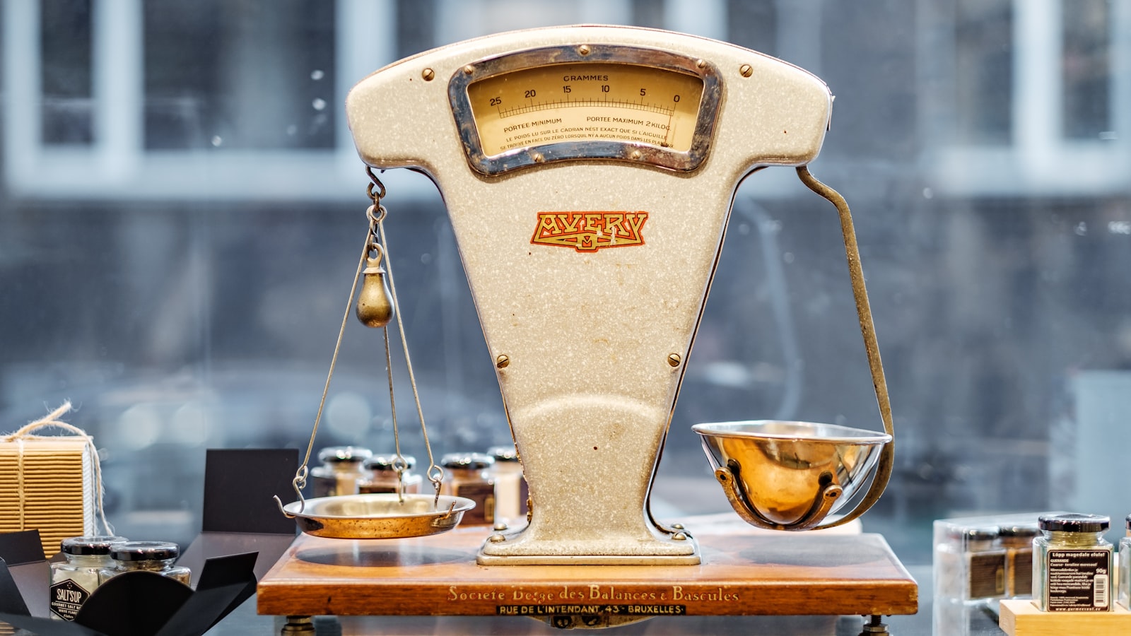 A small brass balance scale on a plain surface