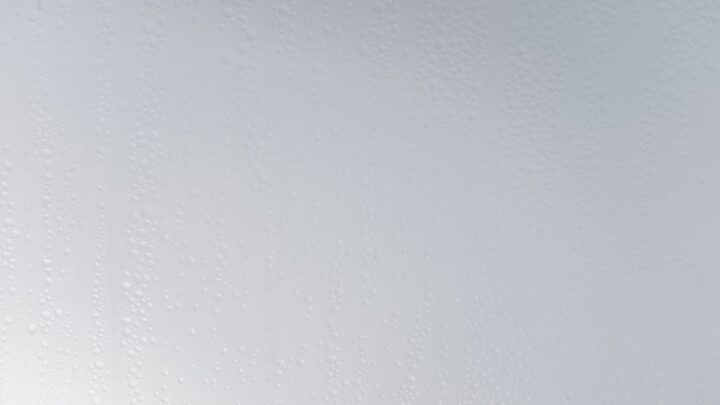 A frosted, frozen surface in cool blue light