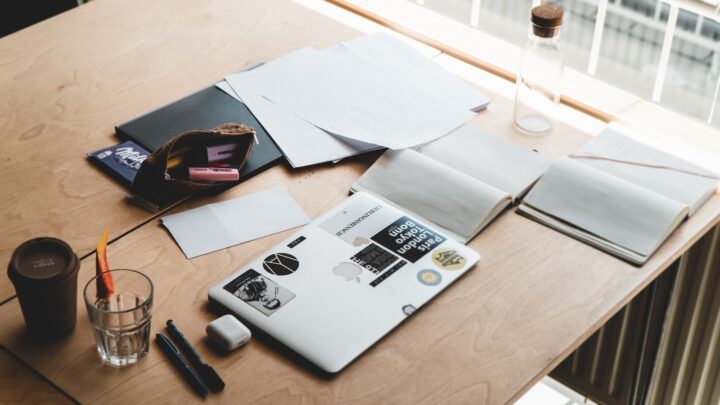 Hourglass on a desk beside documents, representing the divorce timeline in Singapore