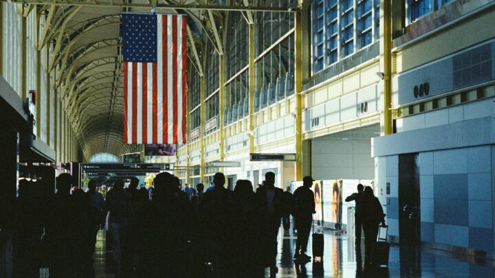 An empty airport walkway with morning light coming through the windows