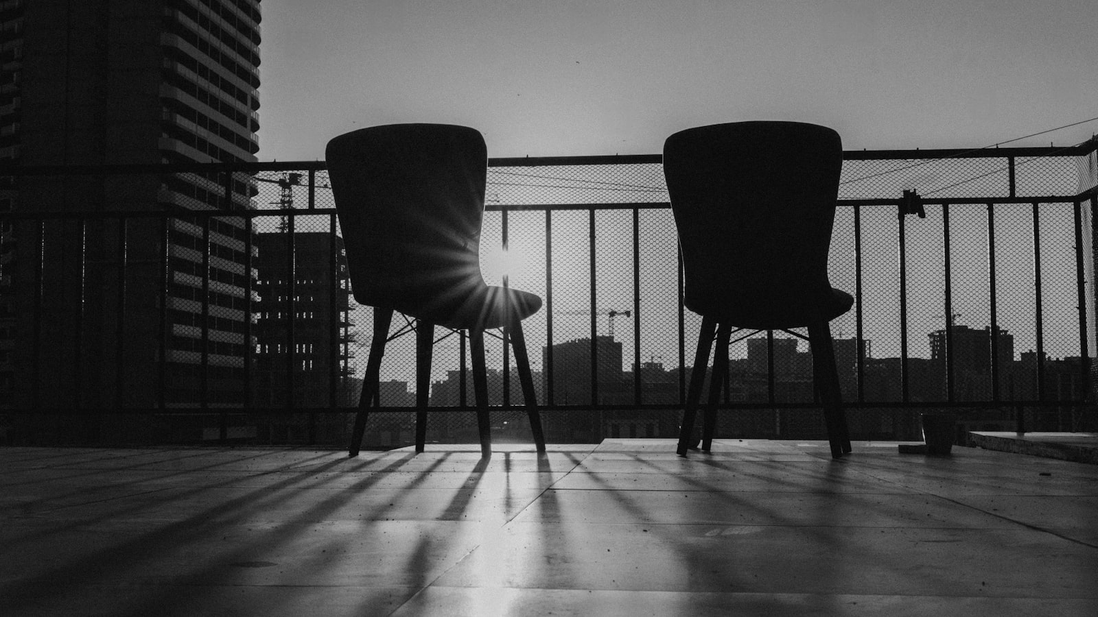 Two empty chairs on a quiet outdoor balcony