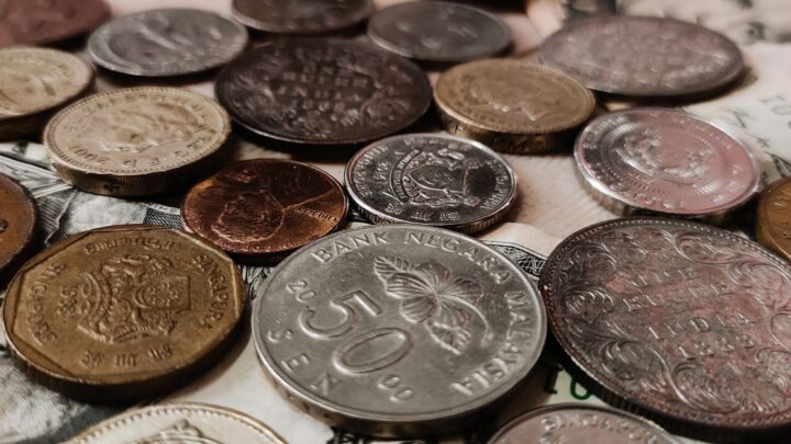 Small stacks of Singapore coins on a plain surface