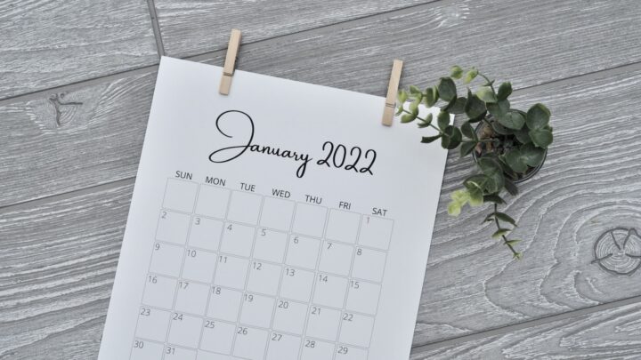 A wall calendar hanging on a plain wall