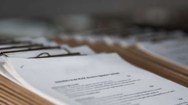 A closed folder of documents resting on a desk