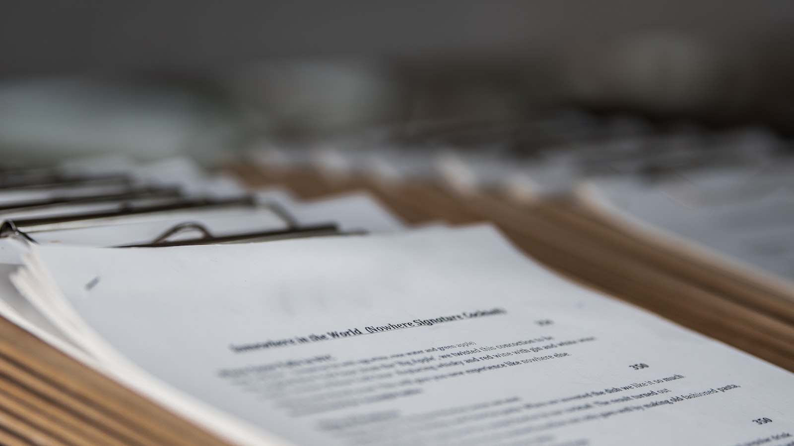 A closed folder of documents resting on a desk