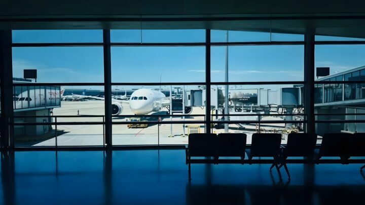 A view of aircraft through the windows of an airport departure terminal