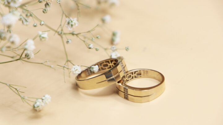 Two gold wedding rings resting on fabric