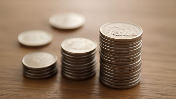 Coins stacked on a wooden surface