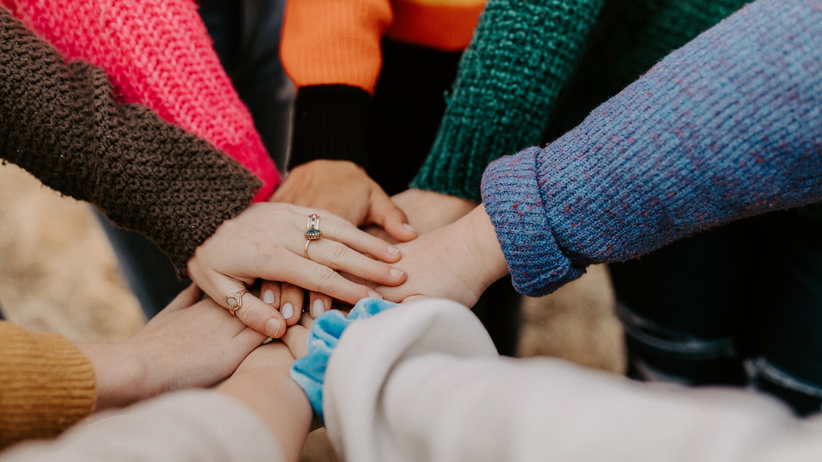 The hands of several family members resting together