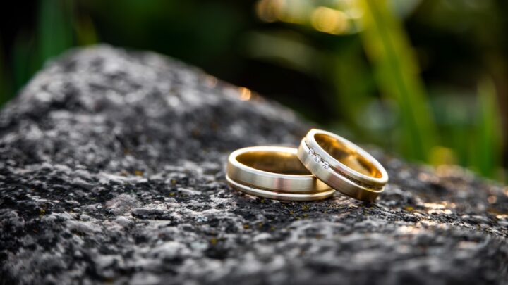 Two plain metal bands resting on a stone surface