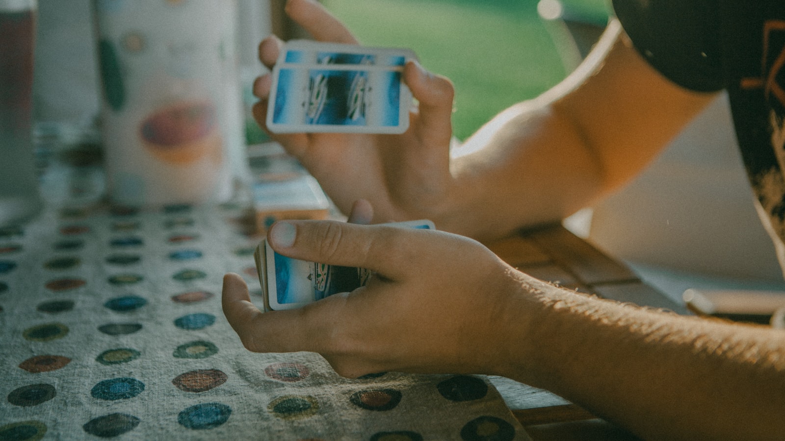 A person holding a mobile phone while sitting at a table