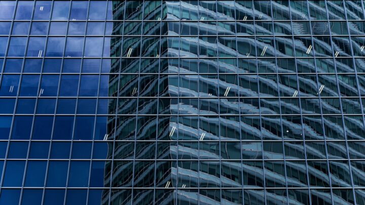 The glass facade of a modern office building in Singapore