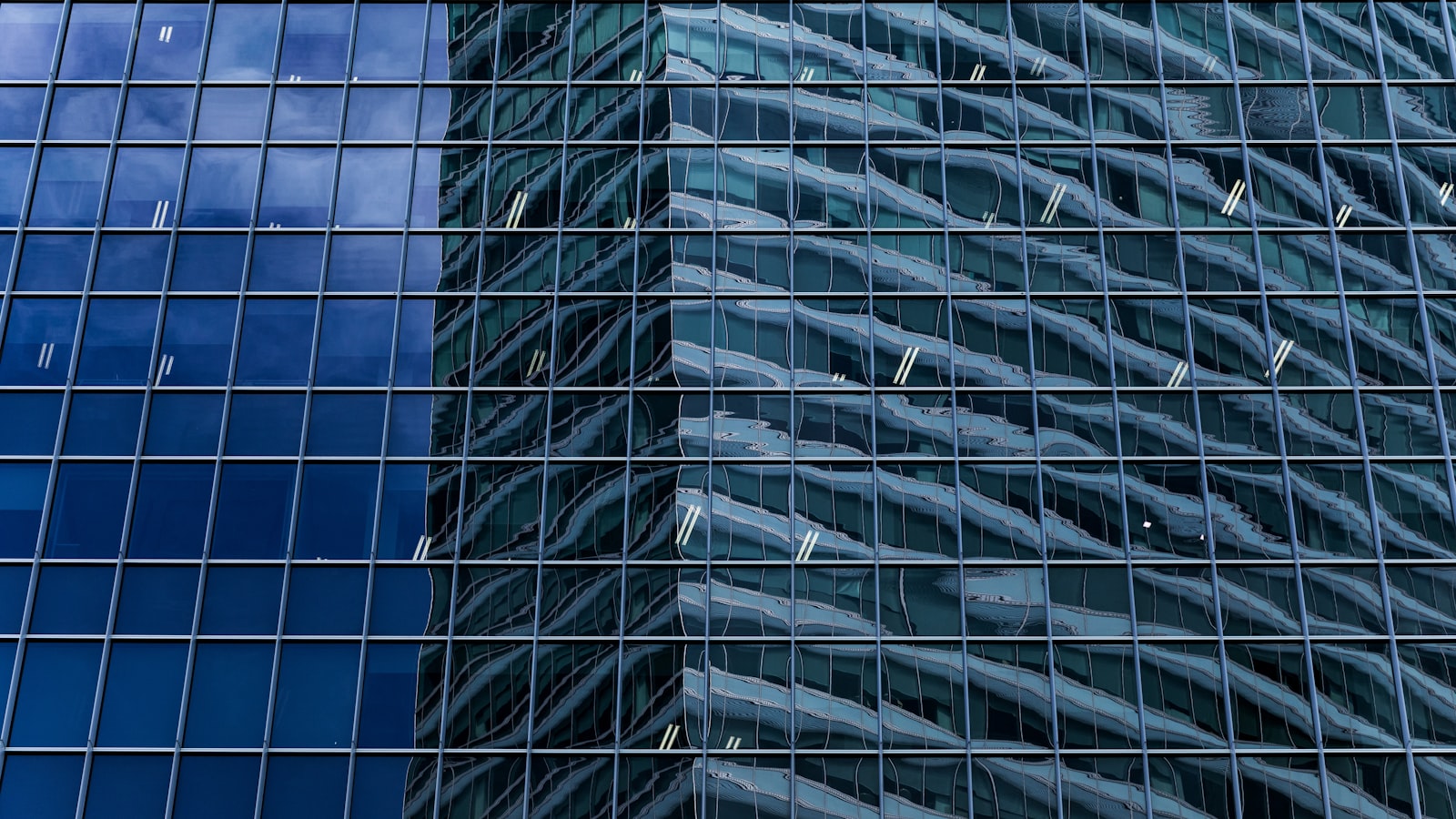 The glass facade of a modern office building in Singapore