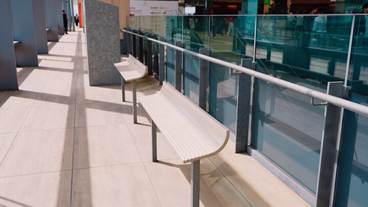 An empty corridor lined with wooden benches