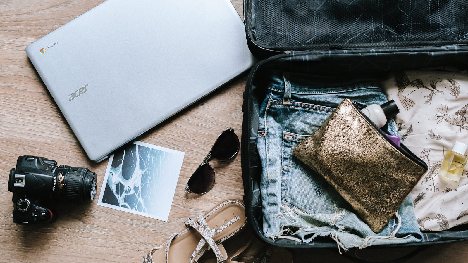 A packed suitcase and passport on a bed