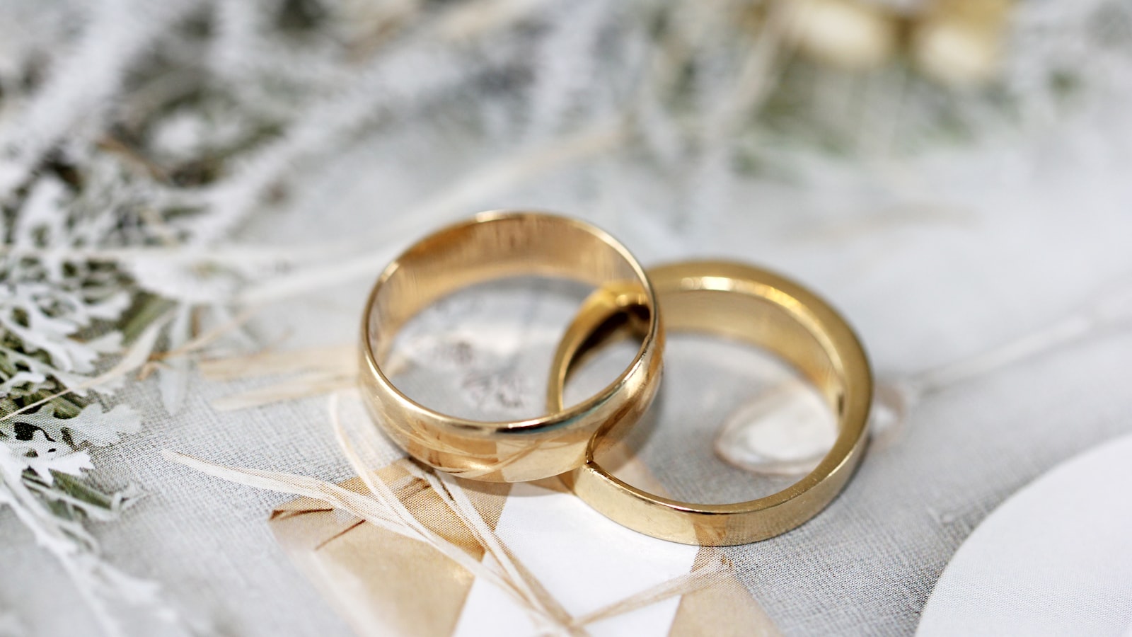 Two plain wedding bands resting on a light surface