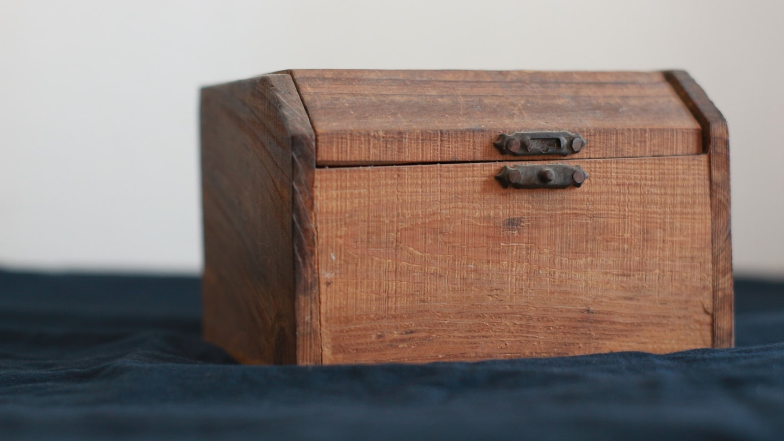 A closed wooden box resting on a desk