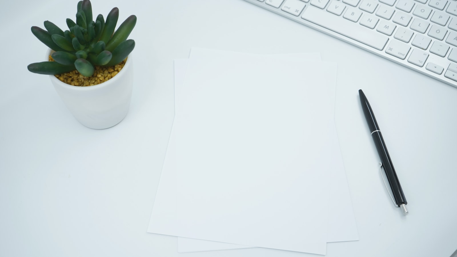 A fountain pen lying across a printed document on a desk