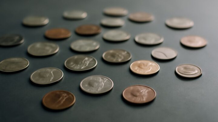 Loose coins scattered across a dark surface
