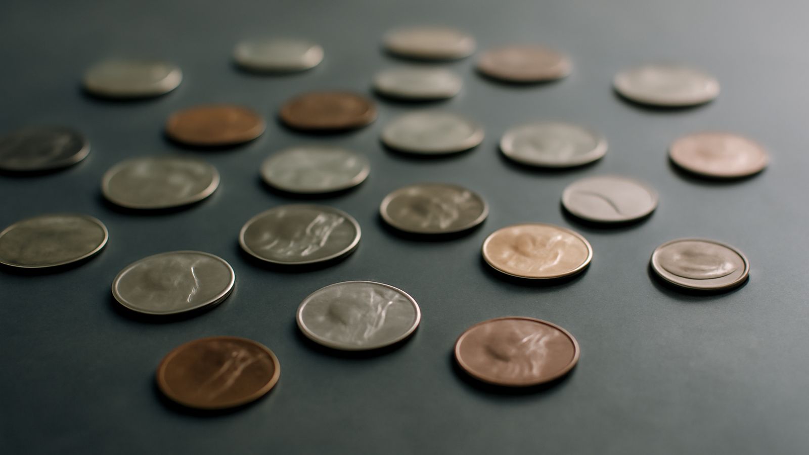 Loose coins scattered across a dark surface